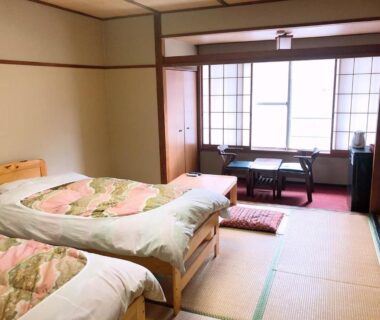 Tatami room with twin beds, shoji screens and low table at Shiobara Onsen Hotel Ohruri, Tochigi