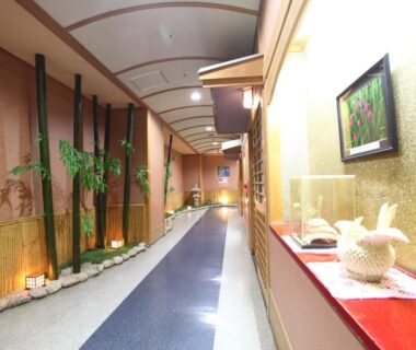 Long corridor with bamboo accents and decorative screens, warm lighting at Shiobara Onsen Hotel Ohruri in Tochigi, Kanto, Japan