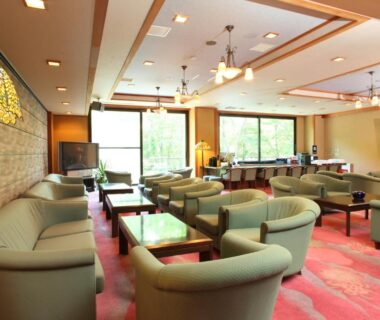 Lounge with sofas and tables at Shirafune Grand Hotel, Nagano