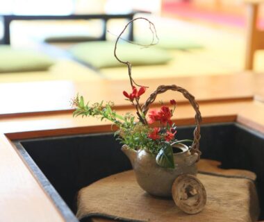 Ikebana floral arrangement on low table in tatami room at Shirafune Grand Hotel, Nagano