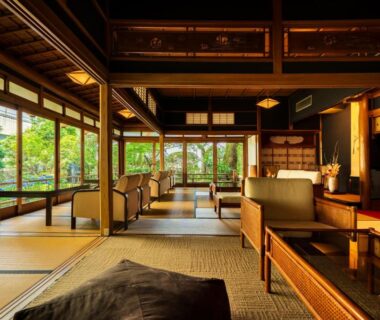 Spacious tatami lounge with wooden beams and garden view at Shiragiku in Oita Kyushu