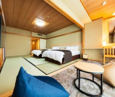Tatami room with twin beds and low seating at Shiragiku ryokan in Oita, Kyushu, Japan
