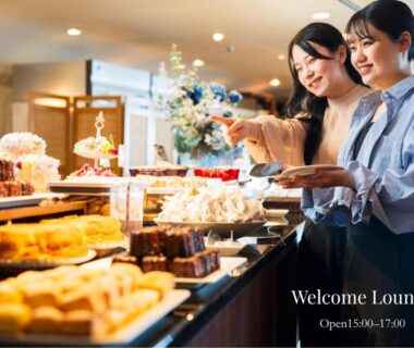Guests selecting desserts at a welcome lounge buffet inside Shiragiku ryokan in Ōita, Kyūshū