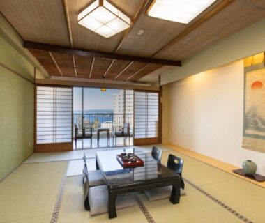 Spacious tatami room with low table, zaisu chairs, shoji screens and balcony at Shirahama Onsen Kisyu Hanto, Wakayama