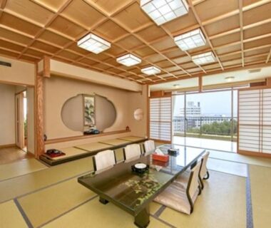 Spacious tatami room with low table and floor seating, shoji screens, sliding glass doors at Shirahama Onsen Kisyu Hanto Wakayama