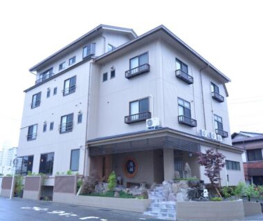 Four story ryokan building with balconies and stone entrance, Shirahama no Yado Daigo, Wakayama