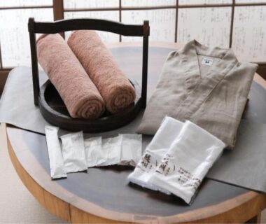 Yukata, rolled towels and toiletries on table by shoji at Shirahama no Yado Daigo Wakayama