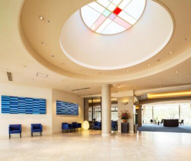 Spacious lobby with circular skylight, blue wall art and seating at Shiraraso Grand Hotel, Wakayama, Kansai
