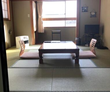 Tatami room with low table and zaisu chairs at Shiunso in Tochigi