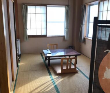 Quiet tatami room with low table, zaisu chairs and shoji windows at Shiunso in Tochigi
