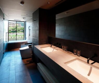 Double vanity and freestanding tub in minimalist bathroom at Shizuru 鴨川, Kyoto