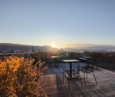 Rooftop wooden terrace with chairs and sunrise at Shizuru 鴨川 in Kyoto