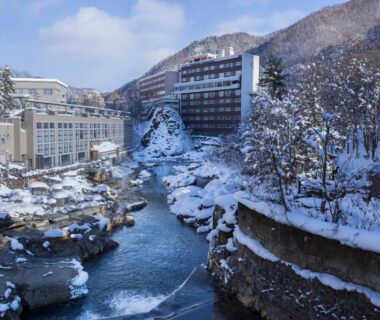 Snow-covered river valley with hotels and bridges near Shogetsu Grand Hotel, Hokkaidō