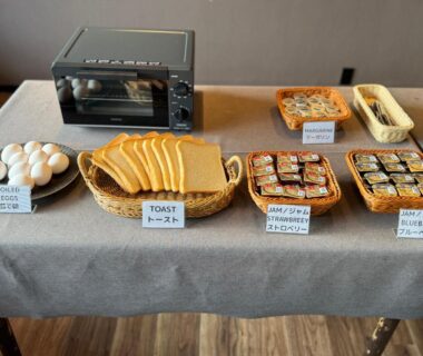 Buffet table with sliced bread, eggs, toaster oven and condiment packets at Shoji Lake Hotel, Yamanashi