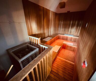 Indoor wooden bathing tubs with steps and warm ambient lighting at Shoji Lake Hotel, Yamanashi