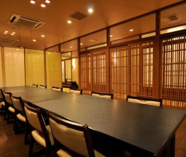 Long table with cushioned chairs and wooden shoji screens at Shorenkan Yoshinoya, Kyoto