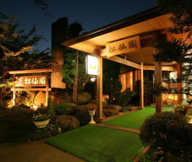 Illuminated ryokan entrance with stone path and greenery at Shosenkaku, Nagano, Chūbu Japan
