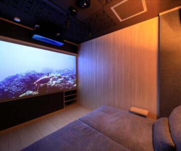 Low light screening lounge with sofa and large projector screen at Shouhakutei Azumaso, Yamagata Tohoku Japan