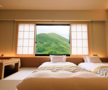 Twin beds on tatami with shoji window framing green mountain, Shouhakutei Azumaso, Yamagata Tōhoku Japan