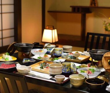 Assorted small Japanese dishes on low table in shoji-screen room at Shouhakutei Azumaso, Yamagata