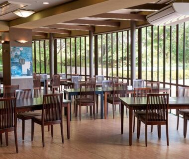 Wooden dining area with large windows and garden view at Shuzenji Onsen Hotel Takitei in Shizuoka