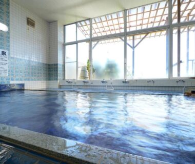 Tiled indoor onsen bath with large windows at Simamegurinoyado Sakai in Miyagi Tōhoku