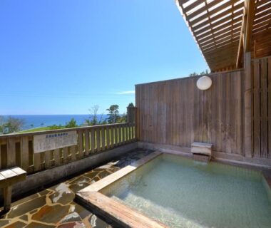 Wooden outdoor onsen bath on terrace overlooking sea at Simamegurinoyado Sakai in Miyagi, Tōhoku