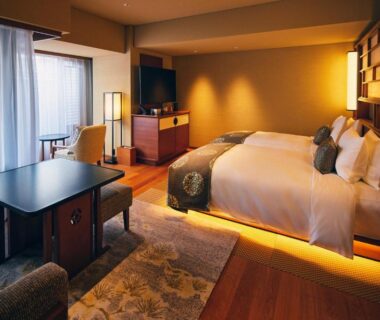 Modern guestroom with bed, low table and balcony at Sora Niwa Terrace Kyoto Bettei in Kyoto, Kansai