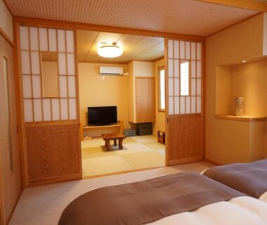 Japanese tatami room with shoji screens, twin beds and low table at Soumeian in Gunma, Kantō
