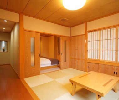 Traditional tatami room with low table, shoji screens and adjacent futon alcove at Soumeian, Gunma, Kantō