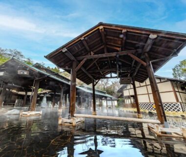 Covered outdoor onsen bath with wooden pavilion and steam at Spa Resort Hawaiians, Fukushima