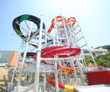 Colorful twisting enclosed and open water slides at Spa Resort Hawaiians Monolith Tower, Fukushima