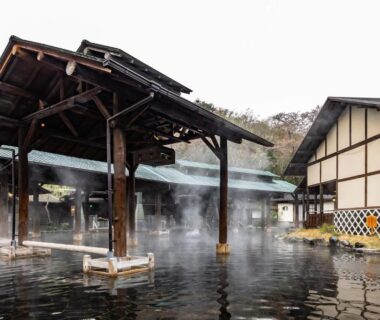 Steaming outdoor onsen pool with wooden pavilion at Spa Resort Hawaiians in Fukushima, Tōhoku