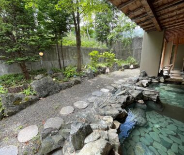 Stone-edged onsen bath with garden view at Spa and Esthetique Suichokan Hokkaidō