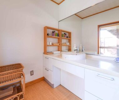 Double sink vanity with large mirror, wicker basket and window at Spa&Resort Kujukuri Taiyou-no-sato, Chiba
