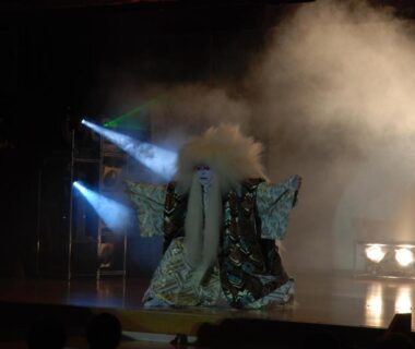 Masked performer in ornate costume on a smoky stage at Spa&Resort Kujukuri Taiyou-no-sato, Chiba
