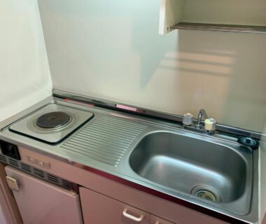 Stainless steel kitchenette with sink and single burner stove at Star Hotel Akakura in Niigata, Chūbu, Japan