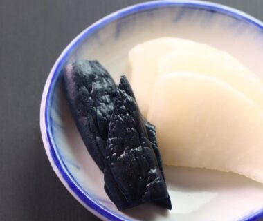 White and dark sliced pickled vegetables in ceramic dish at Star Hotel Akakura, Niigata