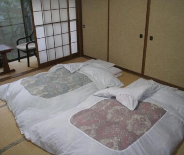 Traditional tatami room with two futons, shoji screens and low table at Suehirokan, Niigata
