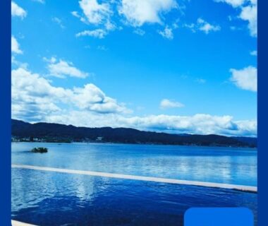 Calm lake under a bright blue sky at Sui Suwako in Nagano Chūbu Japan