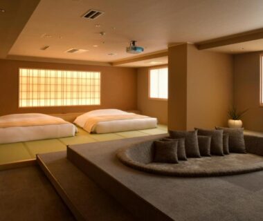 Japanese tatami room with two futons and circular sunken seating nook at Suigan, Hokkaidō