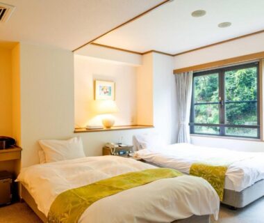 Two single beds by large window with green hillside view at Suizansou, Hyōgo, Kansai