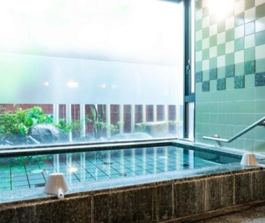 Tiled indoor onsen bath with window overlooking a small garden at Suizansou in Hyōgo, Kansai, Japan