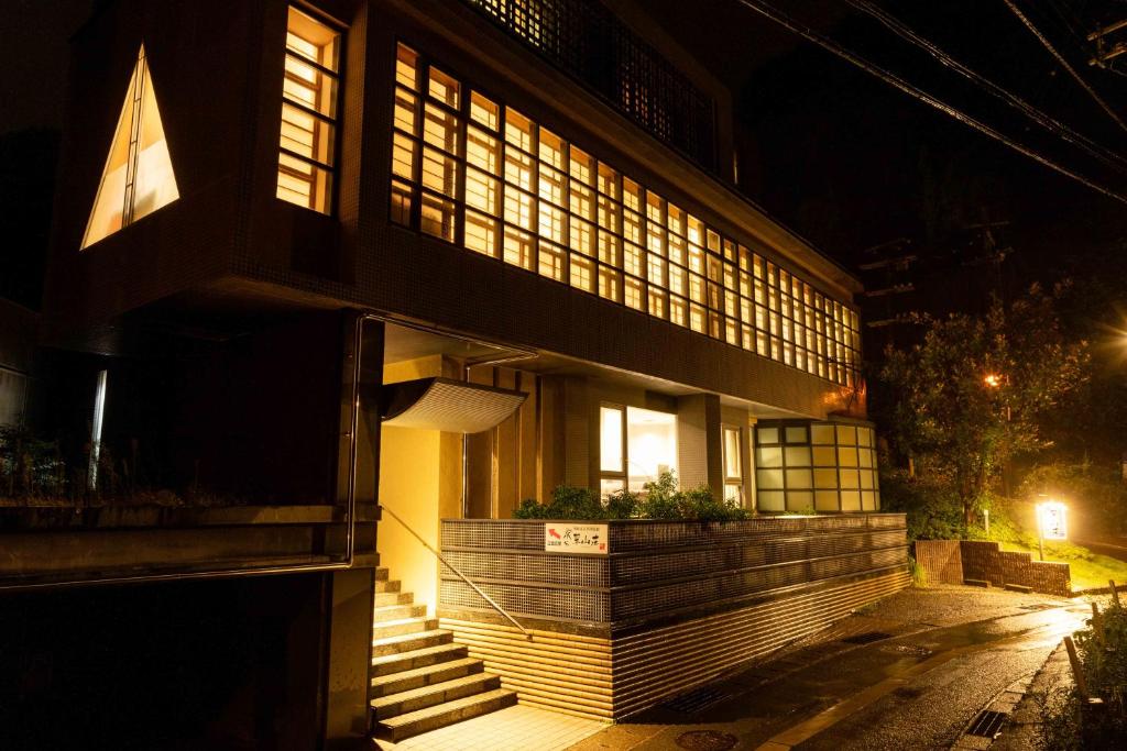 Illuminated ryokan entrance Suizansou Hyōgo Night exterior with lit windows and entrance steps at Suizansou in Hyōgo