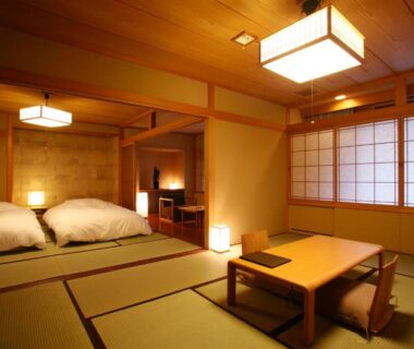 Tatami room with futon beds, low table and shoji screens at Suizantei Club Jozankei Hokkaido