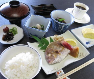 Breakfast tray with rice, grilled fish, miso soup, assorted side dishes, pickles and coffee at Suminoe Ryokan Hiroshima