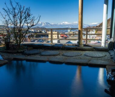 Outdoor onsen bath overlooking town and mountains at Suminoyu, Nagano in Chubu