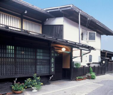 Dark wooden lattice facade and entrance of Sumiyoshi Ryokan in Gifu, Chūbu region, Japan