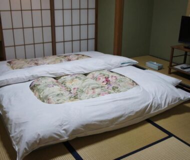 Traditional tatami room with two futons, shoji screens and low table at Sumiyoshiya in Ishikawa, Chūbu region