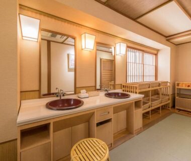 Double sink vanity with wooden stools and shoji window in Sumiyoshiya dressing area Niigata